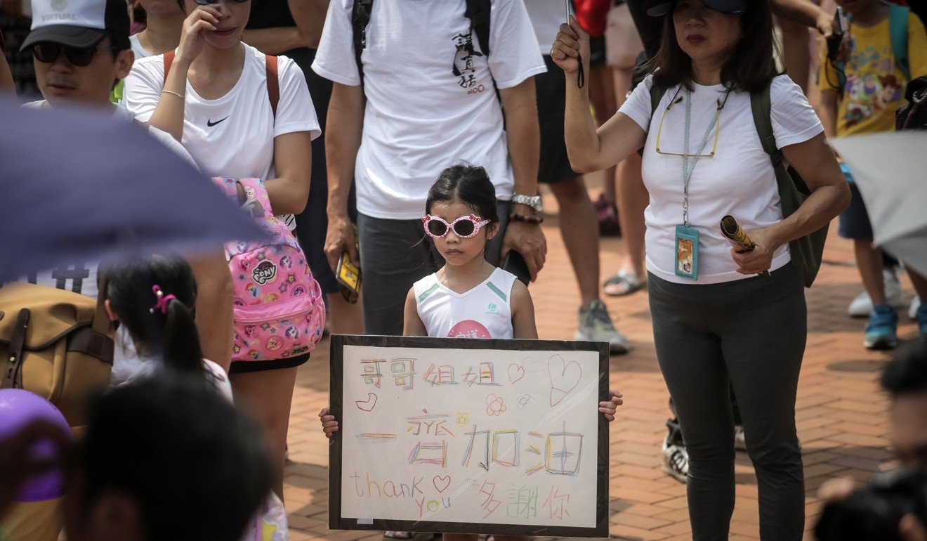 A child holds a sign during an event for families against the extradition bill in Hong Kong in August 2019. Photo: Vivek Prakash/AFP