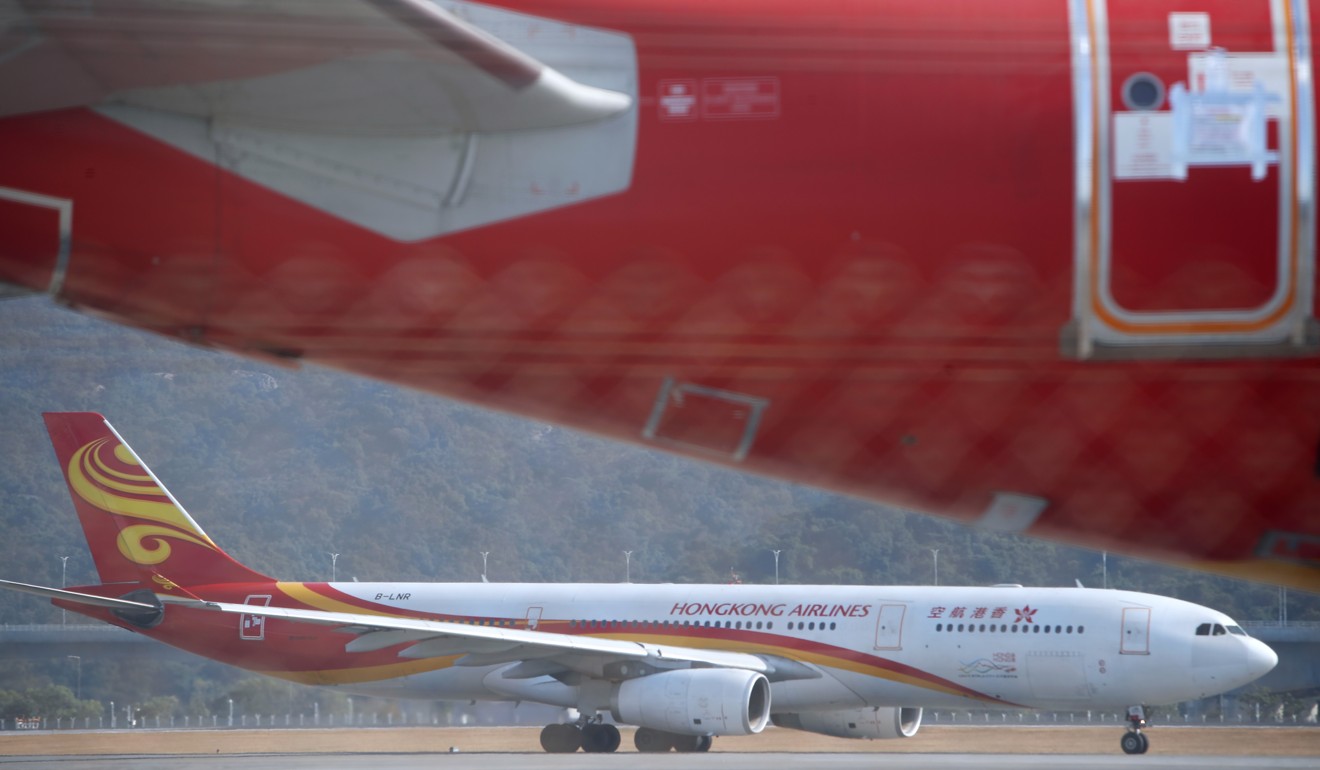 A Hong Kong Airlines passenger aircraft sits on the tarmac. The airline cut 170 jobs this week. Photo: Winson Wong