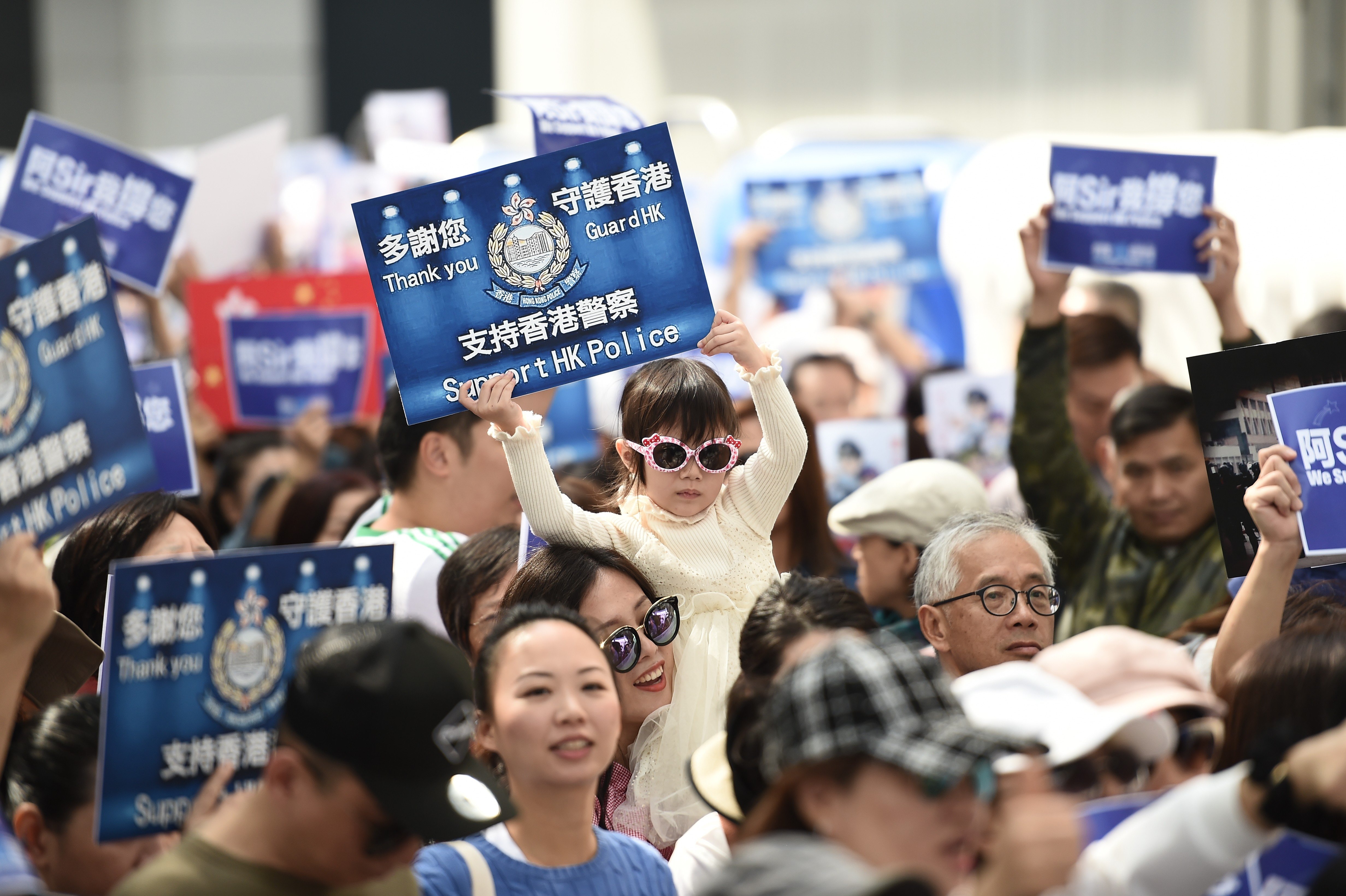 A child holds a placard at a pro-police rally outside the Legislative Council building in Hong Kong in November 2019. Photo: Ye Aung Thu/AFP