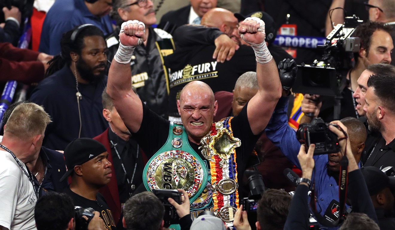 Tyson Fury celebrates with his WBC heavyweight title strap. Photo: DPA