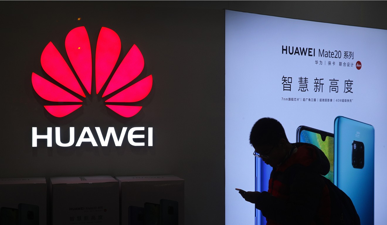 A man browses his smartphone outside a Huawei Technologies store at a shopping centre in Beijing. Photo: AP