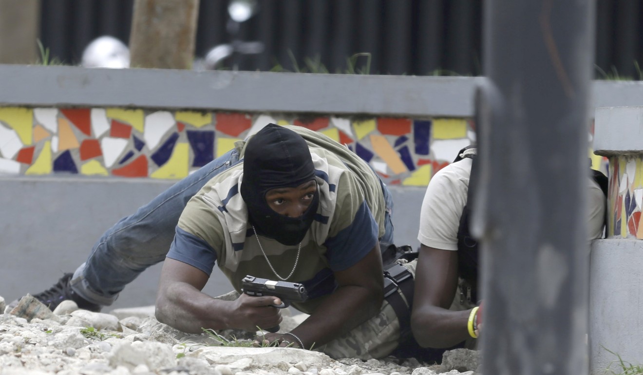 Armed off-duty police officers take cover during the gunfight. Photo: AP