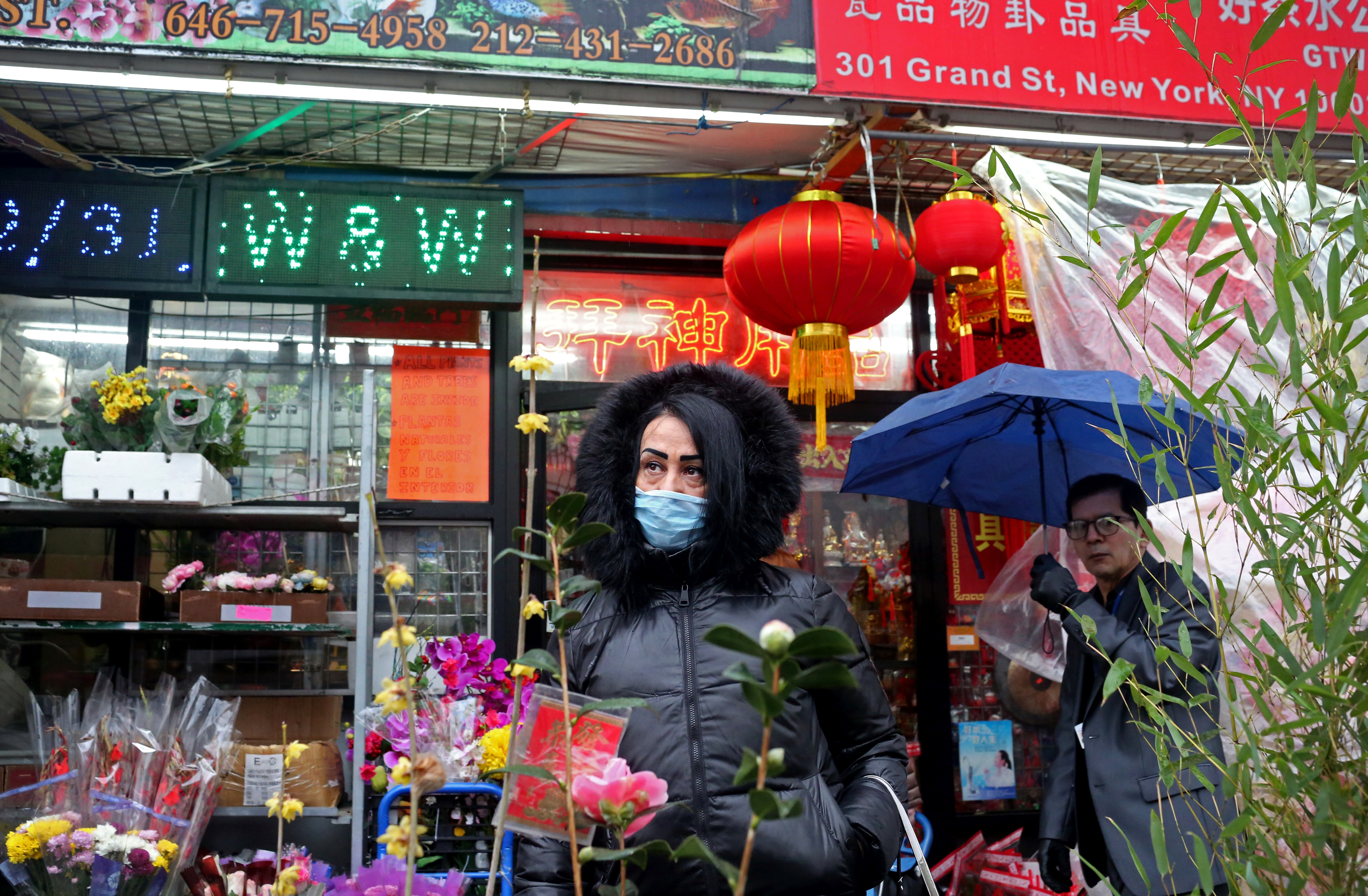 A woman, wearing a mask to protect herself against coronavirus transmission, poses for a photo in New York’s Chinatown on February 13. There are no confirmed coronavirus cases in New York City. Photo: Reuters
