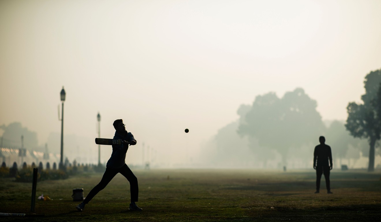 Indian teenagers play cricket in a park despite smoggy conditions in New Delhi. Photo: AFP