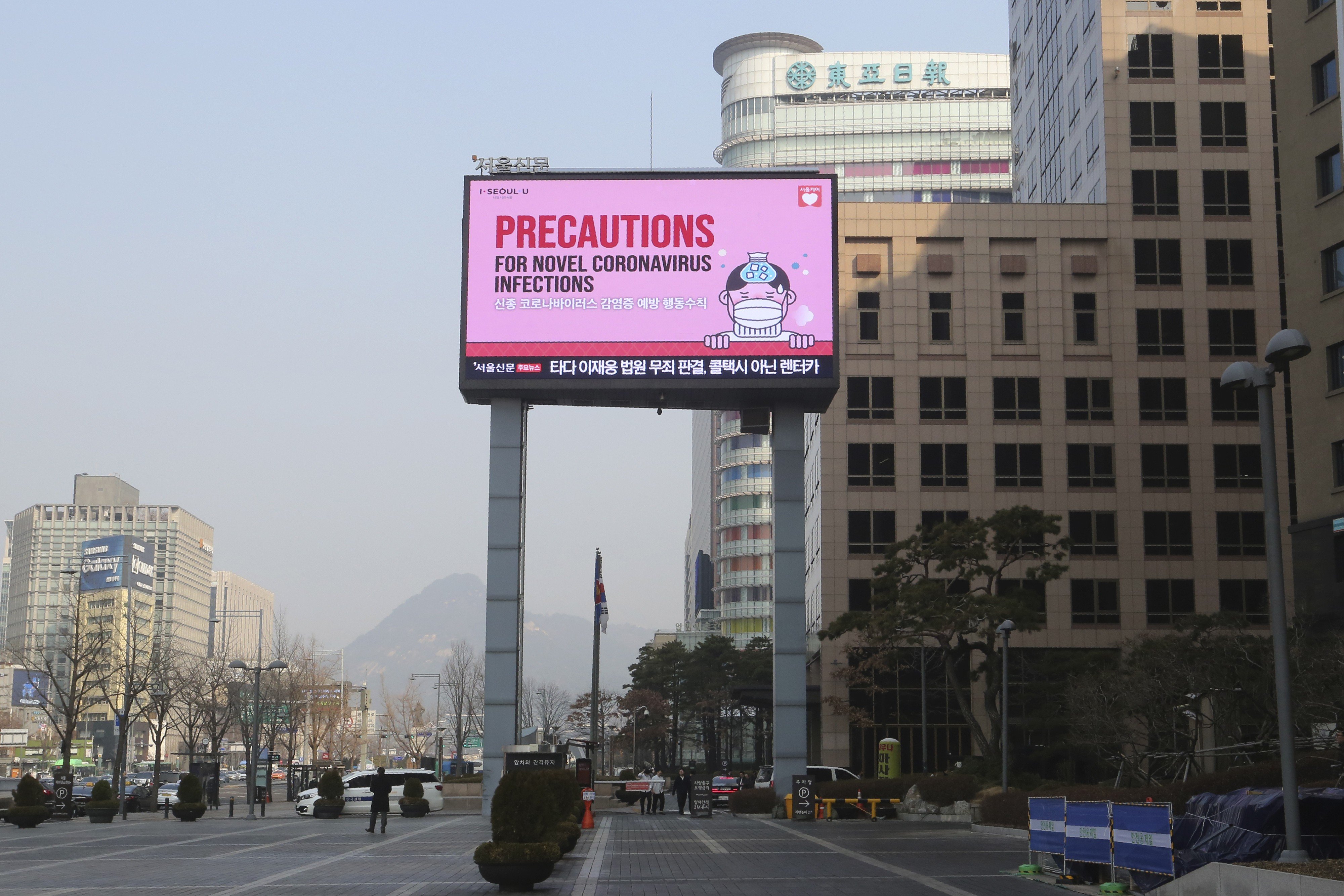 A screen shows precautions against the Covid-19 illness in Seoul, South Korea. Photo: AP
