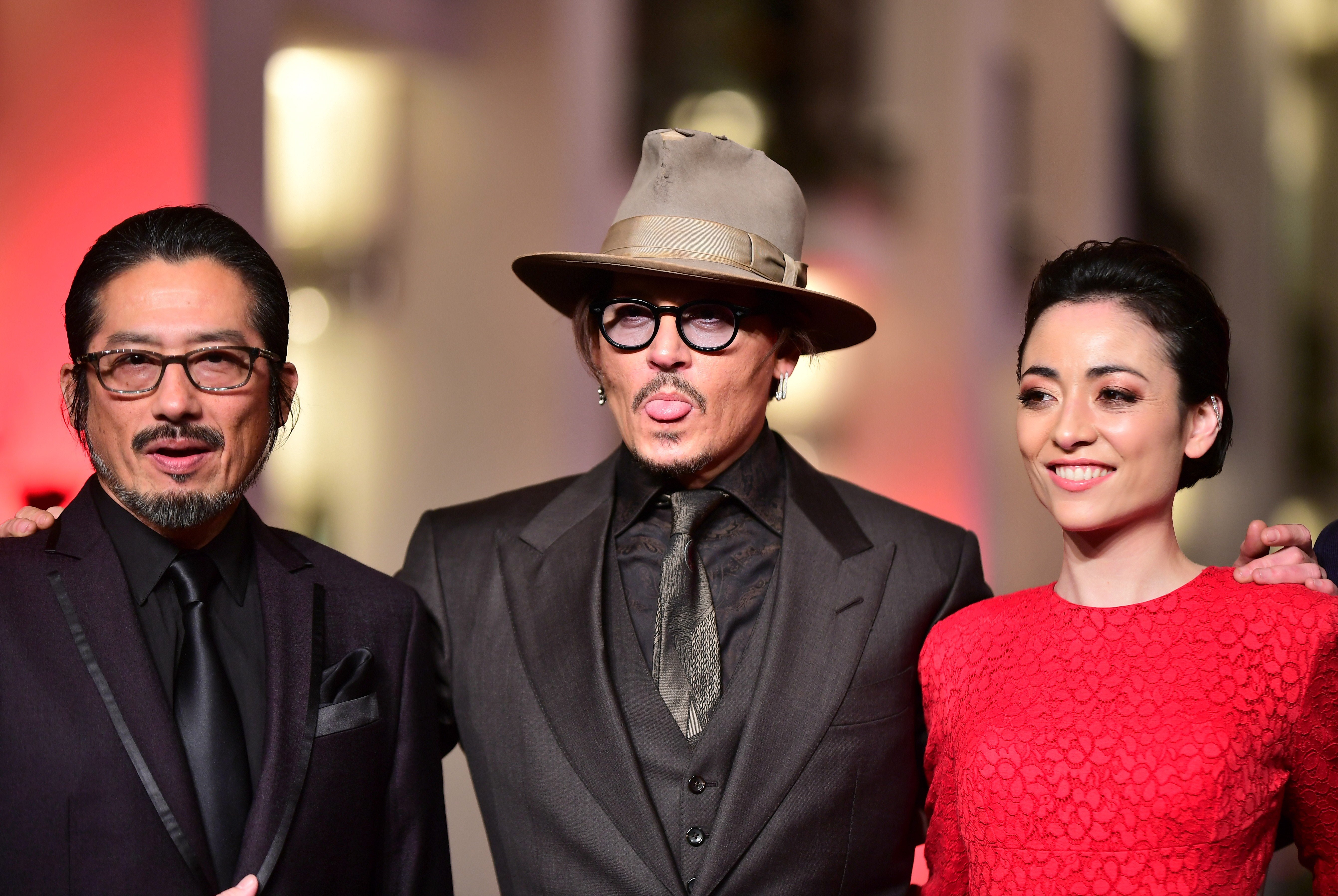 From left: Hiroyuki Sanada, Johnny Depp, and Minami. Photo: EPA-EFE/Clemens Bilan