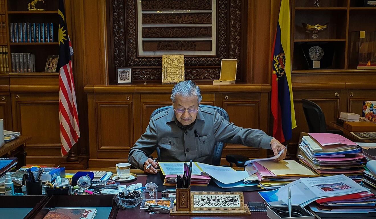 Mahathir Mohamad was back at work in his office in Putrajaya the day after he resigned and was subsequently appointed interim Prime Minister. Photo: AFP