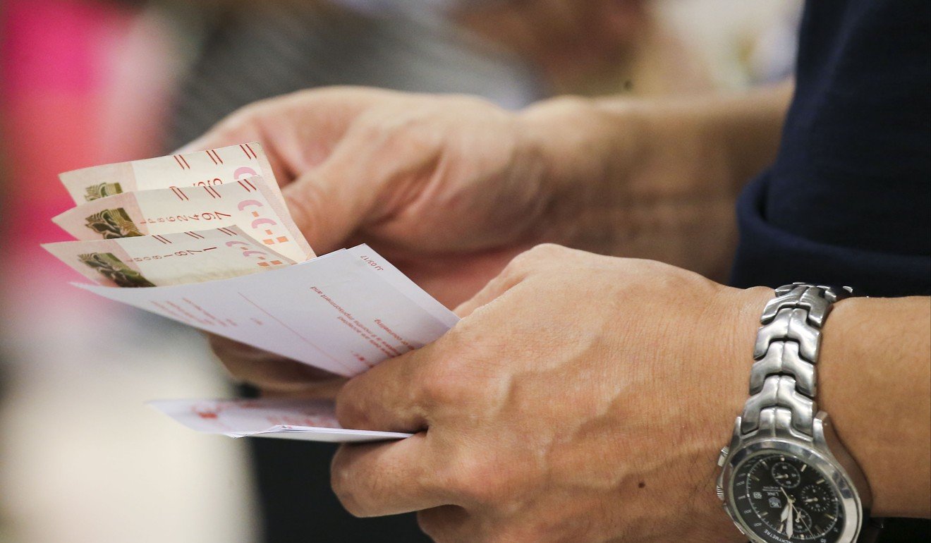 A punter checks betting tickets. Photo: Dickson Lee