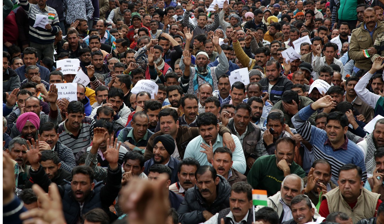 People shout slogans as they block a road during an anti-government in Jammu, India. Photo: EPA-EFE