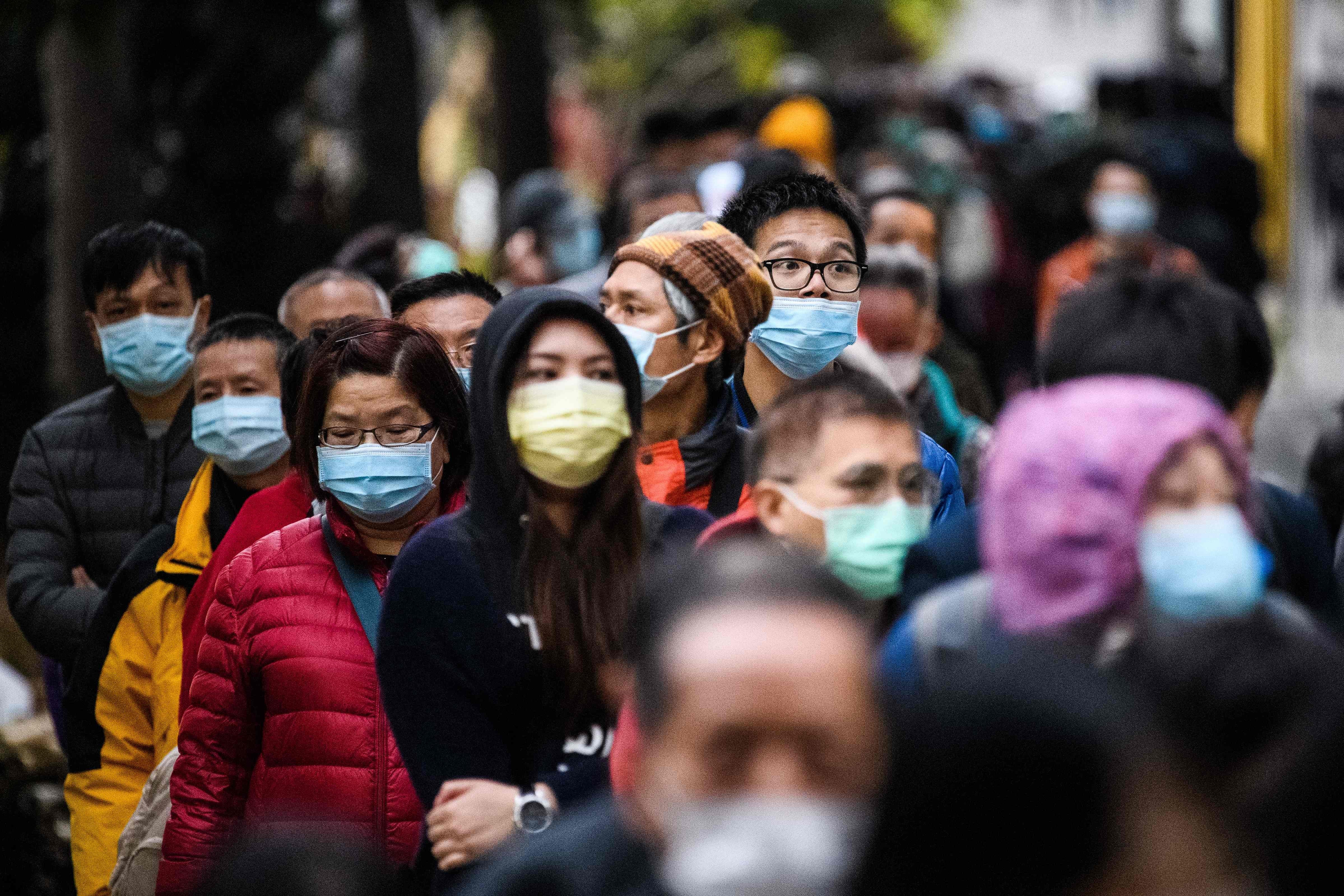 People wearing face masks in Hong Kong queuing up for hours for more masks. Photo: AFP