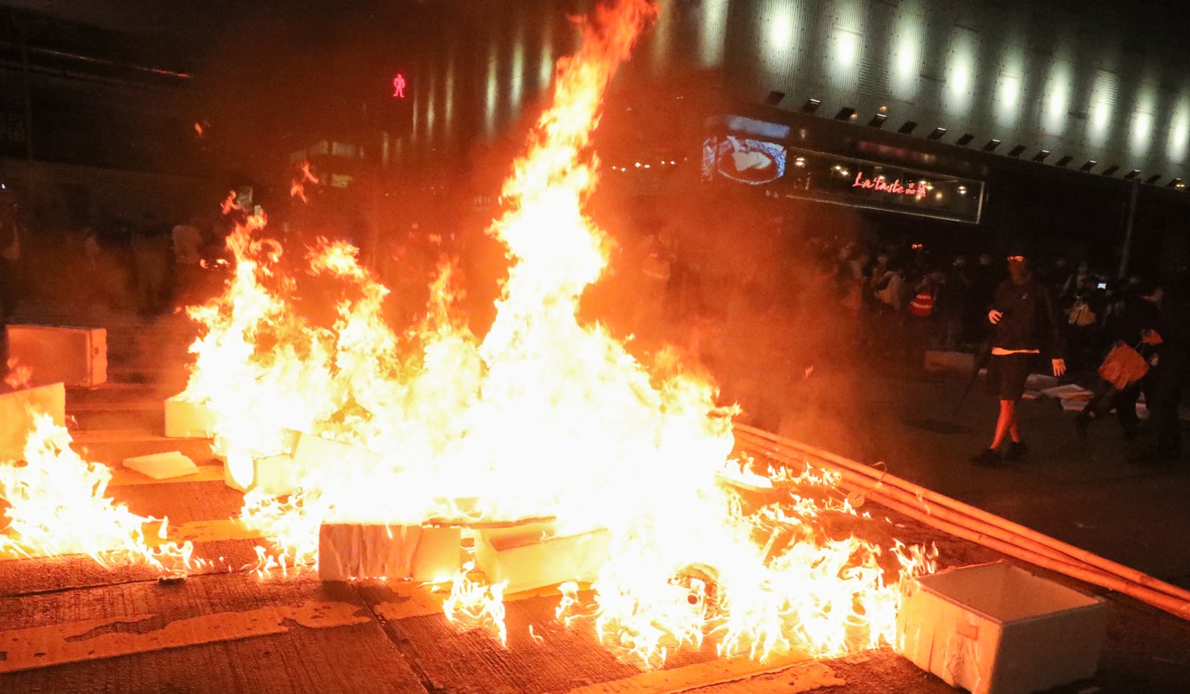 Some protesters set fires in the road during the stand-off. Photo: Felix Wong