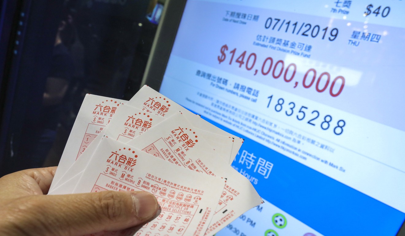 People bet at the Hong Kong Jockey Club betting branch in Wan Chai for the Mark Six draw of HK$140 million. Photo: SCMP/May Tse