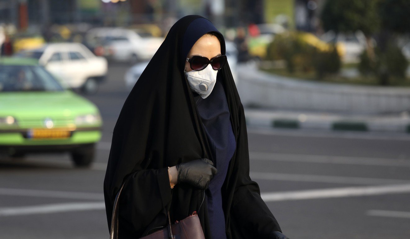A pedestrian, wearing a face mask, crosses a square in western Tehran. Photo: AP