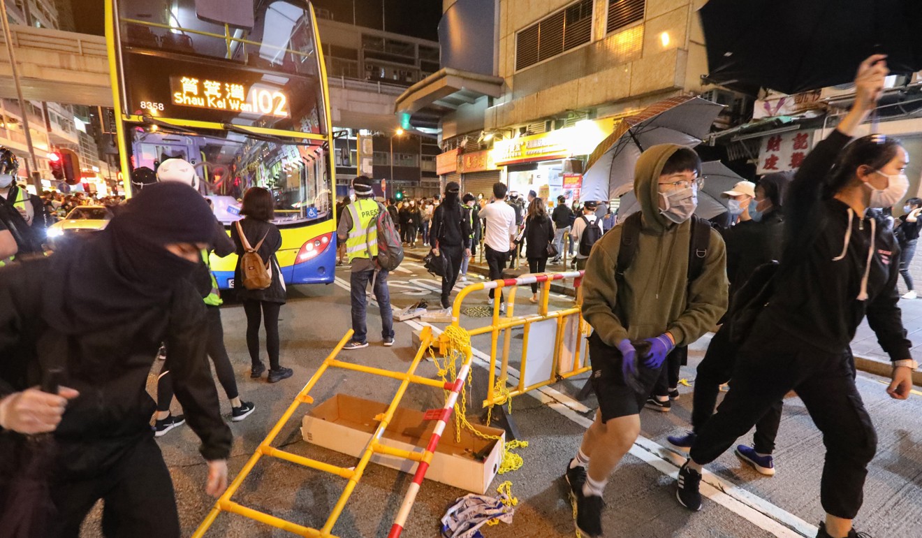 Buses and other vehicles were brought to a standstill when about 100 anti-government protesters took to Nathan Road. Photo: Felix Wong