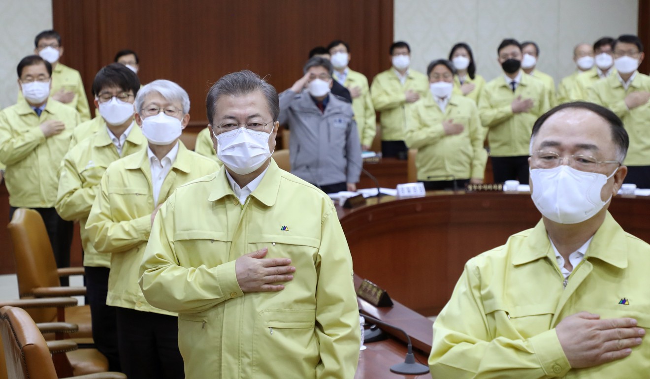 South Korean President Moon Jae-in salutes the national flag during a cabinet meeting. Photo: AP