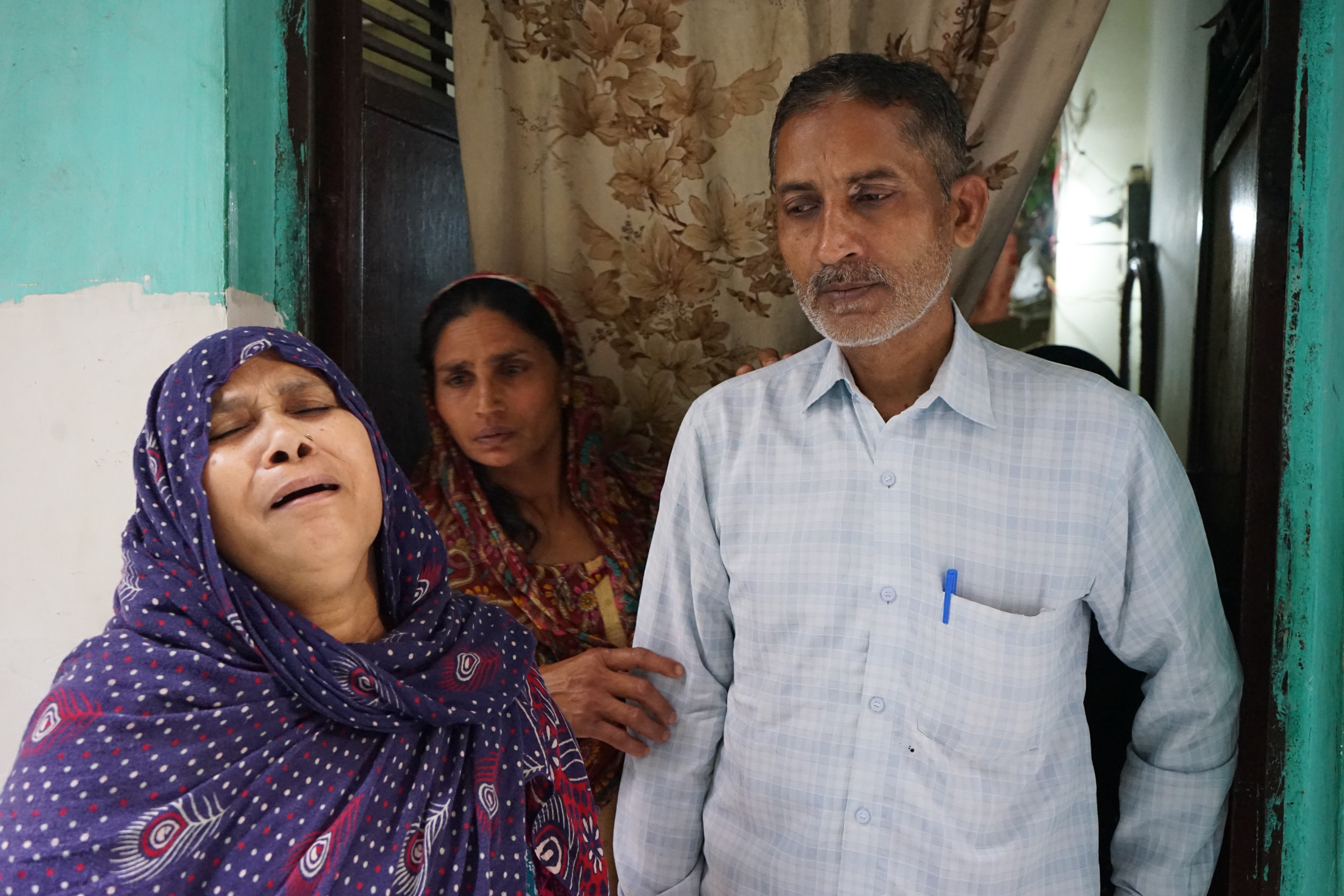 Asgari and Babu, front, lost their two sons in the riots. Photo: Adnan Bhat