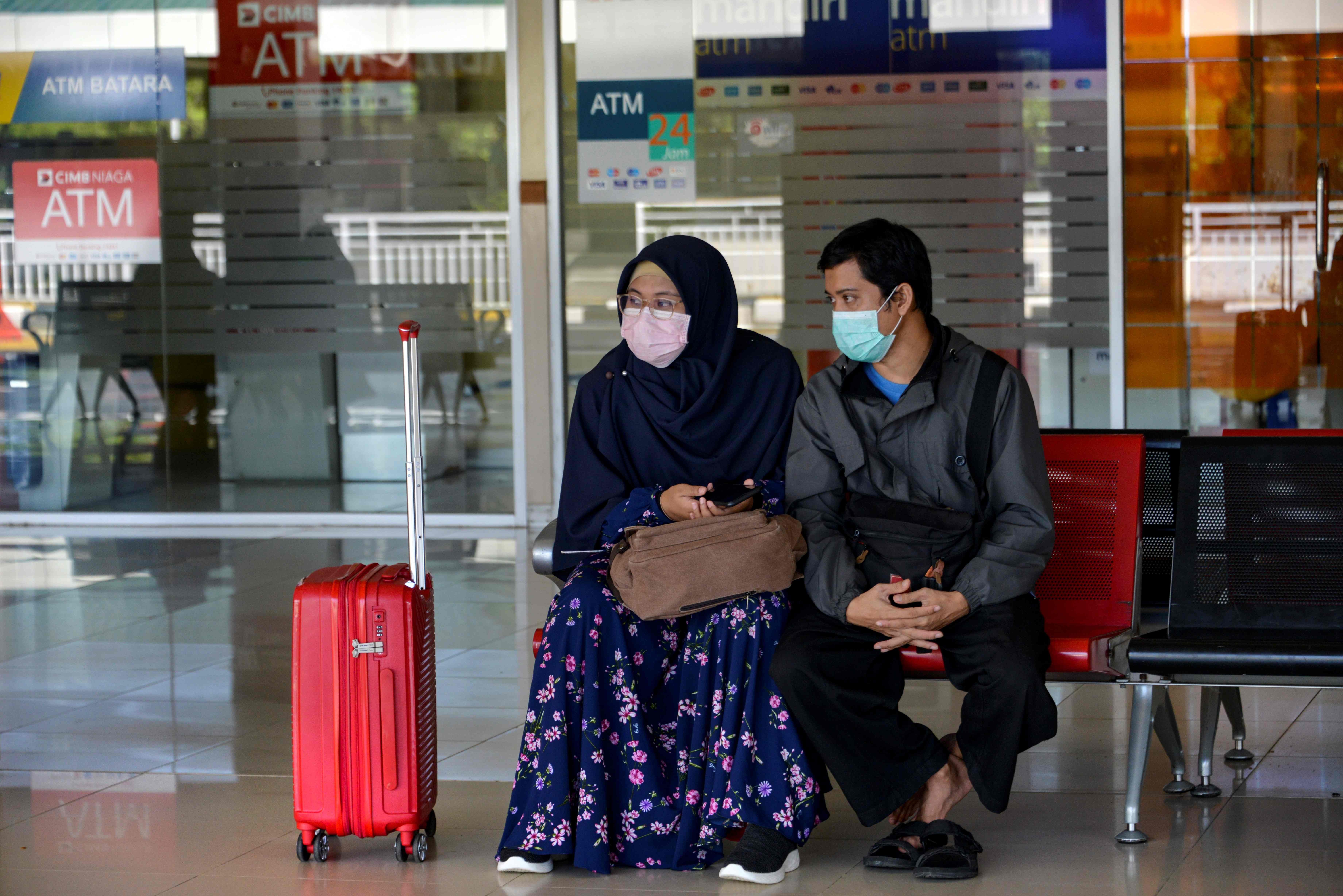 An Indonesian woman and man are pictured at an airport in Aceh Besar. Photo: AFP