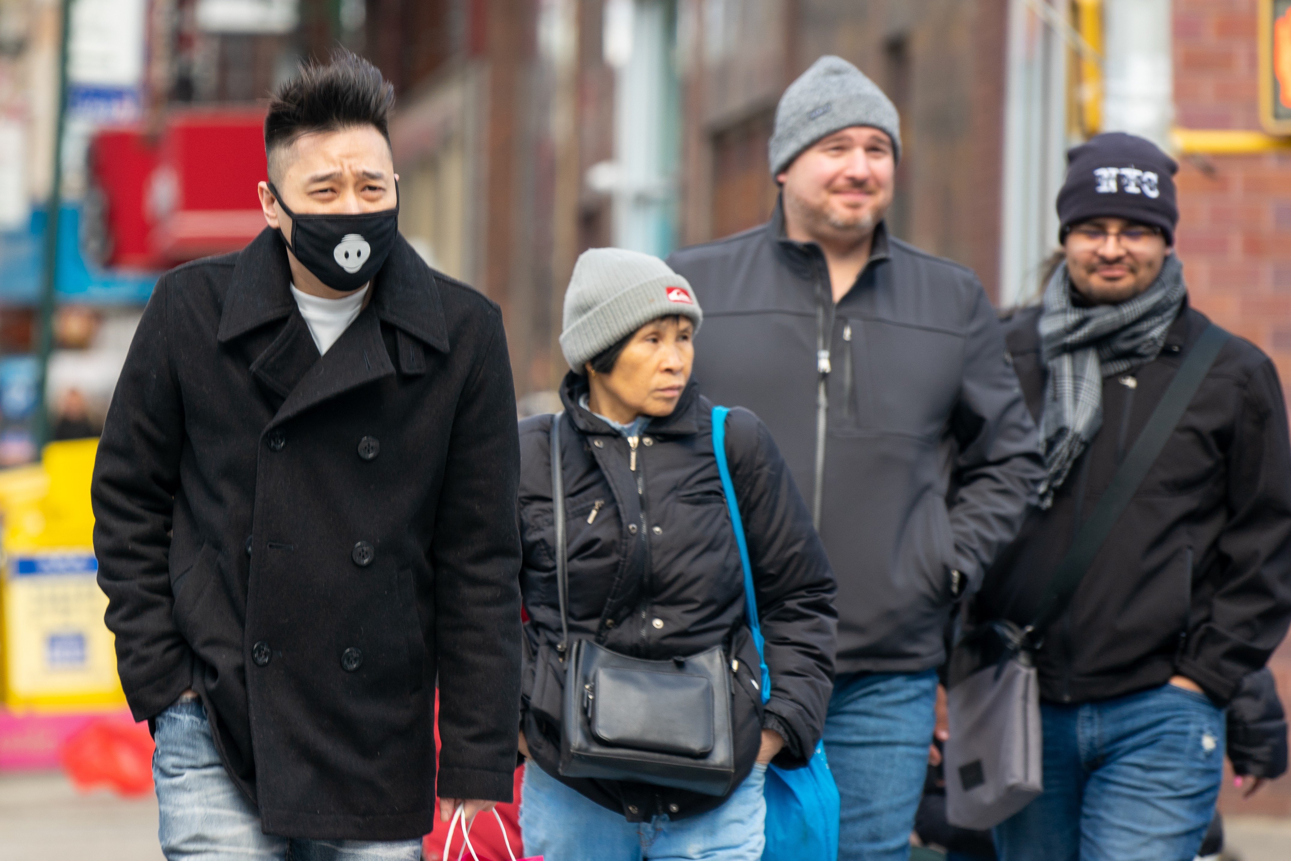 A man wearing a mask walks down a street in Chinatown in New York. Photo: Bloomberg