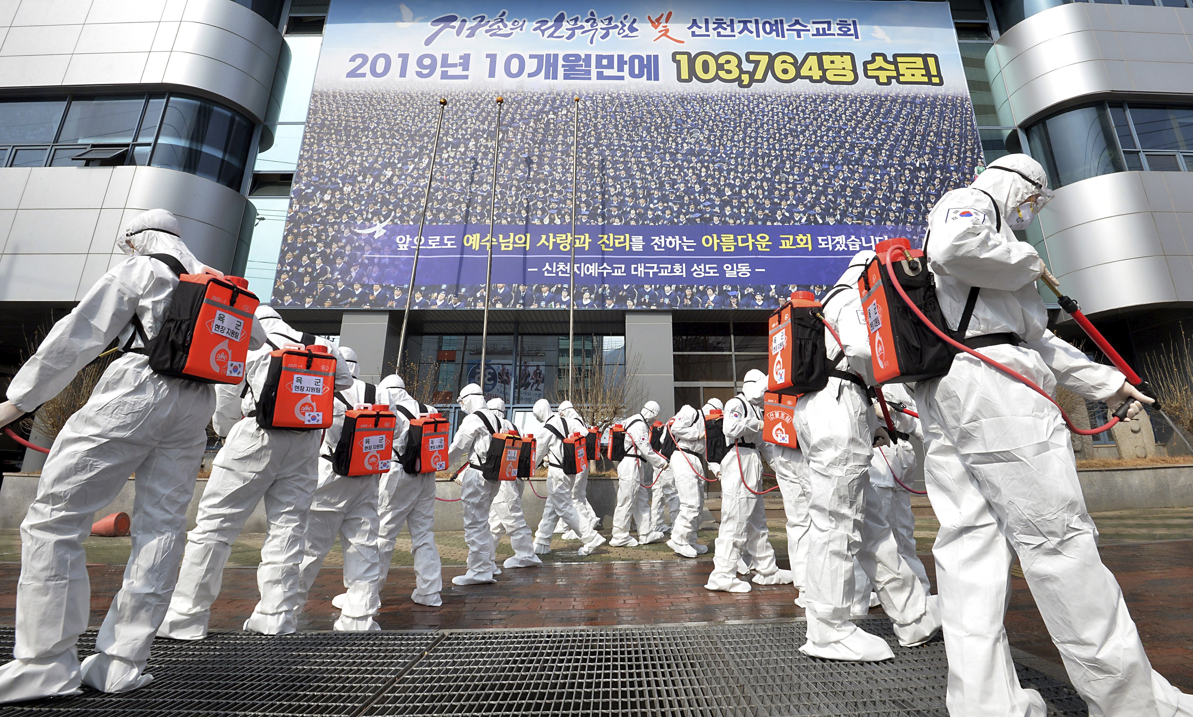 Soldiers in protective suits disinfect the area outside a Shincheonji church in Daegu, South Korea, on March 1, as Covid-19 cases outside China surge. Photo: AP