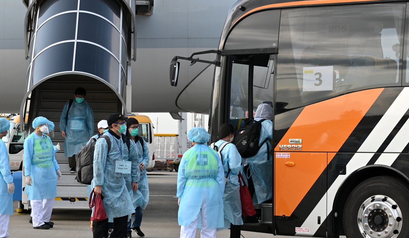 Hongkongers flown in from Wuhan board a bus after landing on home soil. Photo: Handout