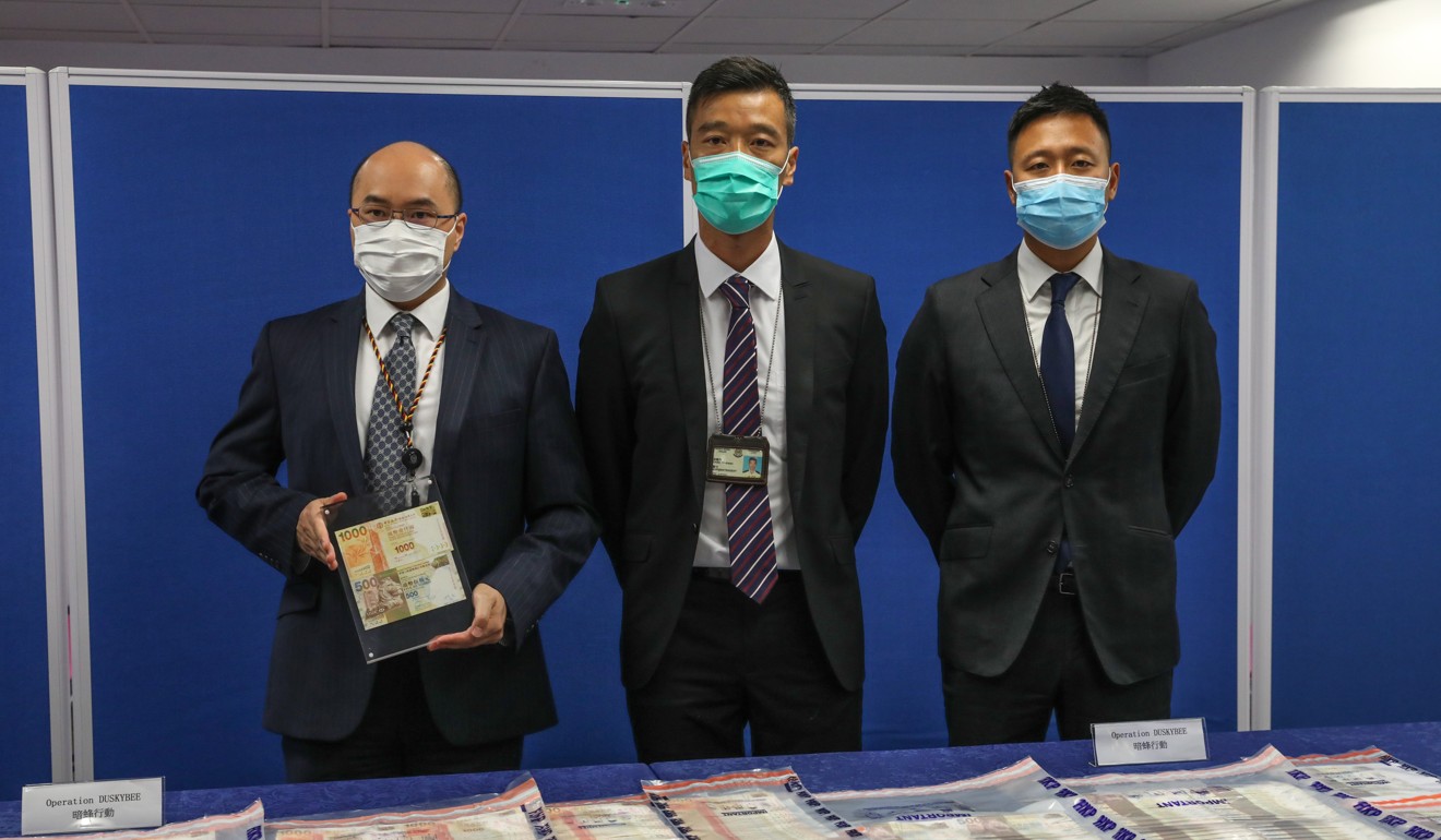 Chief Inspector Brian Tang, Superintendent Joe Chan and Senior Inspector Leung Cheuk-hei display the fake notes used by a syndicate they broke up this week. Photo: Dickson Lee