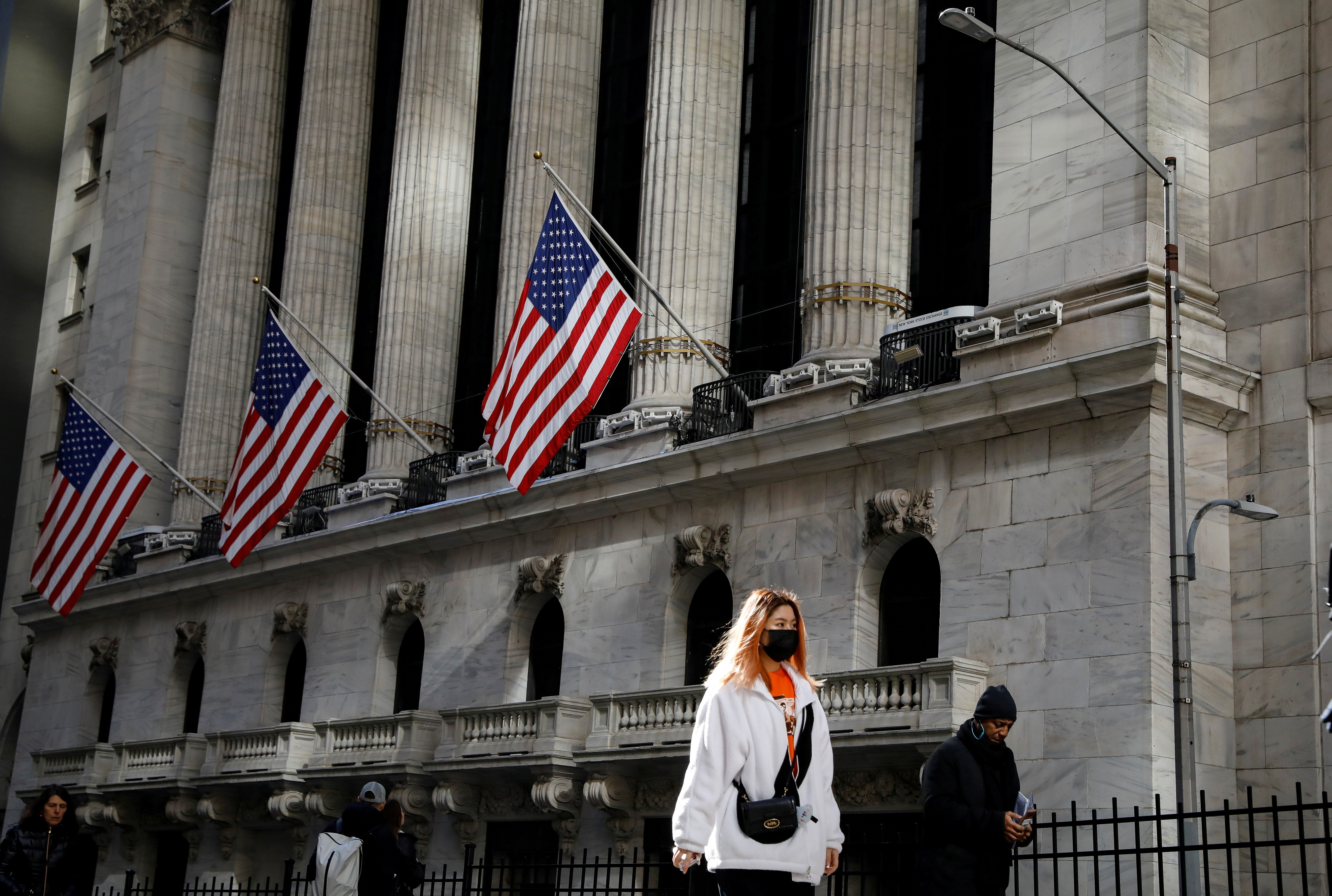 In an uncommon sight in America, a woman wears a mask near the New York Stock Exchange in New York on March 4. Photo: Reuters