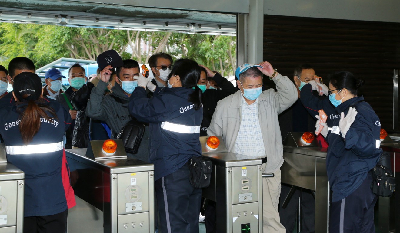 Customers undergo temperature screening to enter Sha Tin on Thursday.