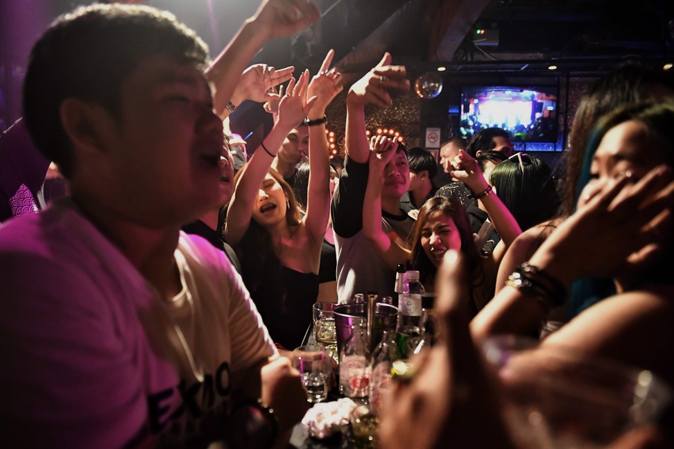 Rap fans enjoy Thai-American rapper Intachai’s set at a club in Bangkok. Photo: AFP