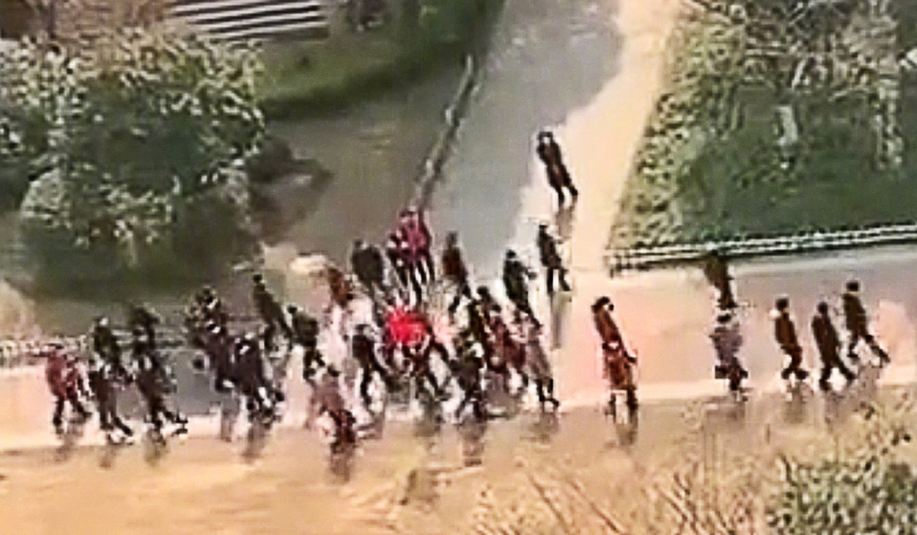 Sun Chunlan and her entourage seen in a still from a video walking through the grounds of the estate as residents shout from their windows. Photo: Weibo