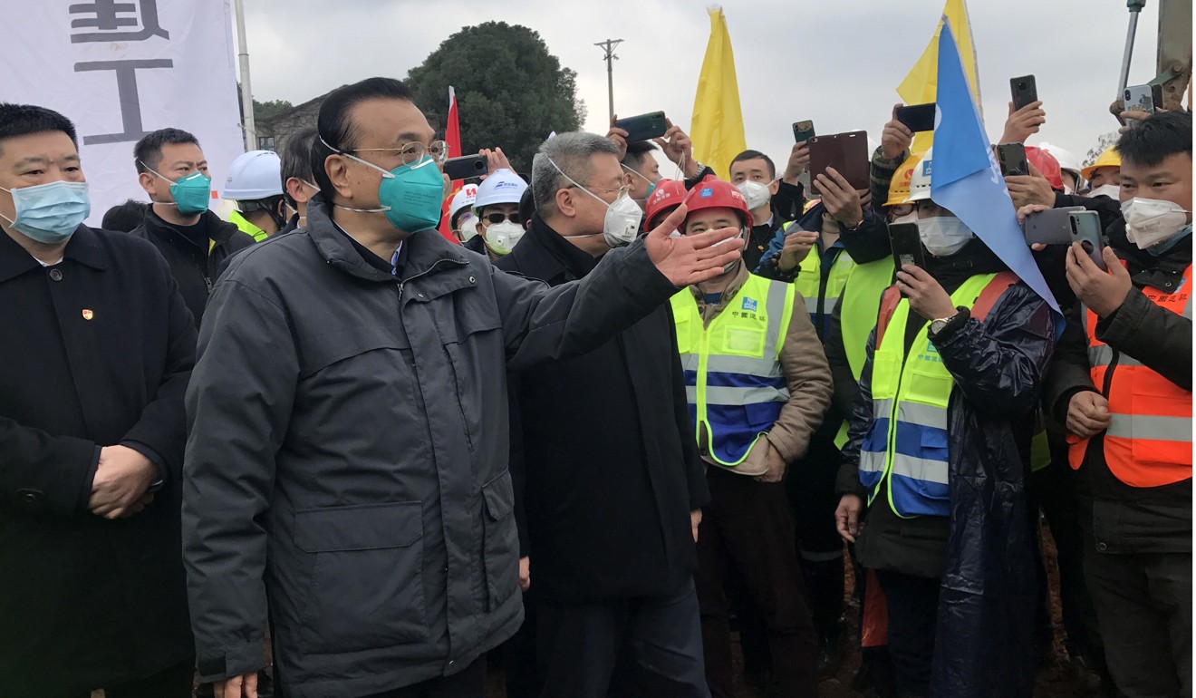 Premier Li Keqiang visits workers at the construction site of a new hospital in Wuhan in January. Photo: EPA-EFE