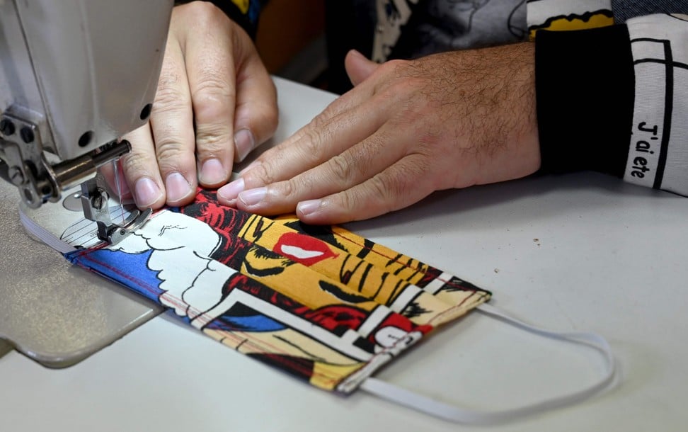 Aragovic works on one of his colourful masks. Photo: AFP