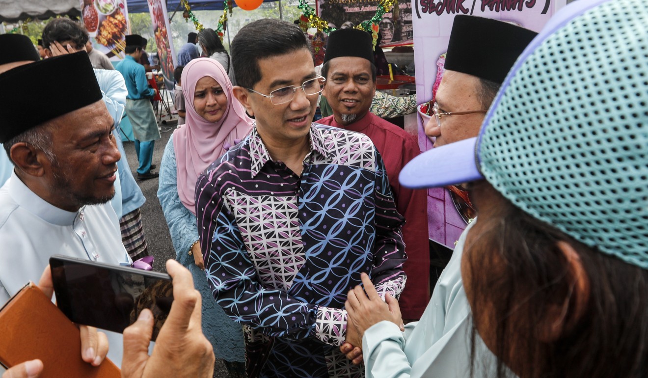 Malaysia’s former economic affairs minister Azmin Ali, centre, pictured in his constituency last year. Photo: EPA