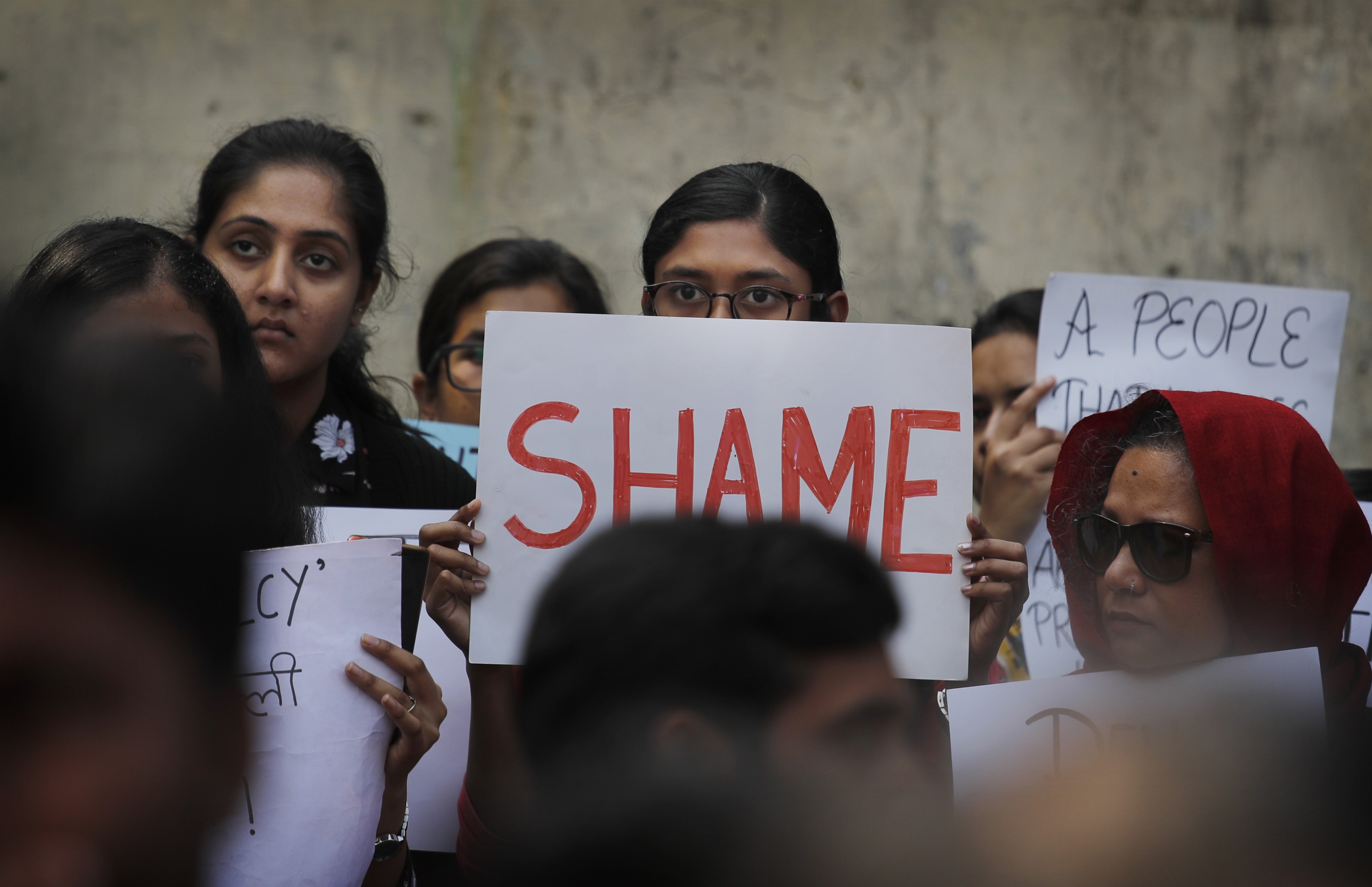Students hold placards protesting against India’s new citizenship law and the recent communal violence in New Delhi. Photo: AP