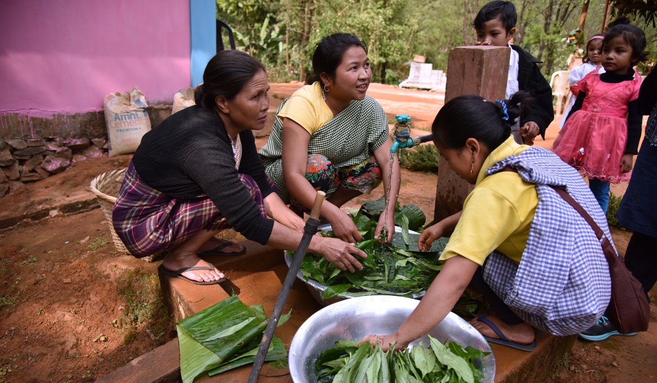 Khasi women wash leaves for cooking in the village of Nongtraw in India’s north-eastern Meghalaya state. Photo: AFP