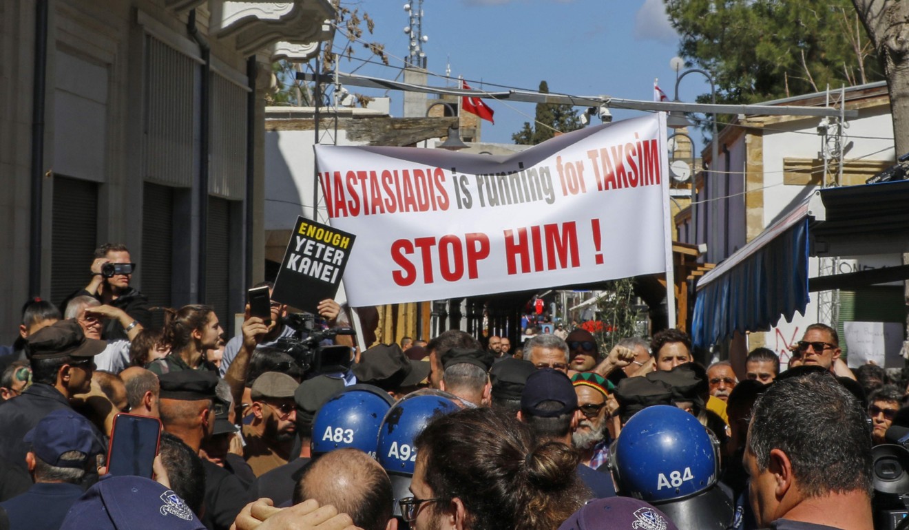 Greek and Turkish Cypriots gather during a demonstration on either side of the Ledra Street crossing in central Nicosia. Photo: AFP