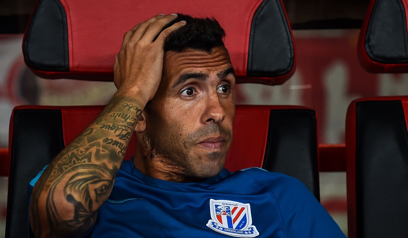 Shanghai Shenhua's Carlos Tevez watches the Chinese Super League Shanghai derby from the bench in 2017. Photo: AFP