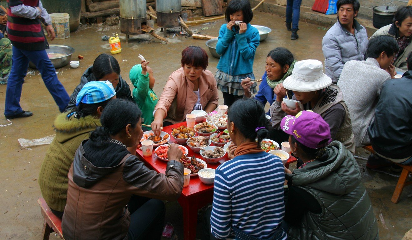 Mosuo people pictured at a wedding ceremony with an all-meat feast in 2013. Photo: Shutterstock