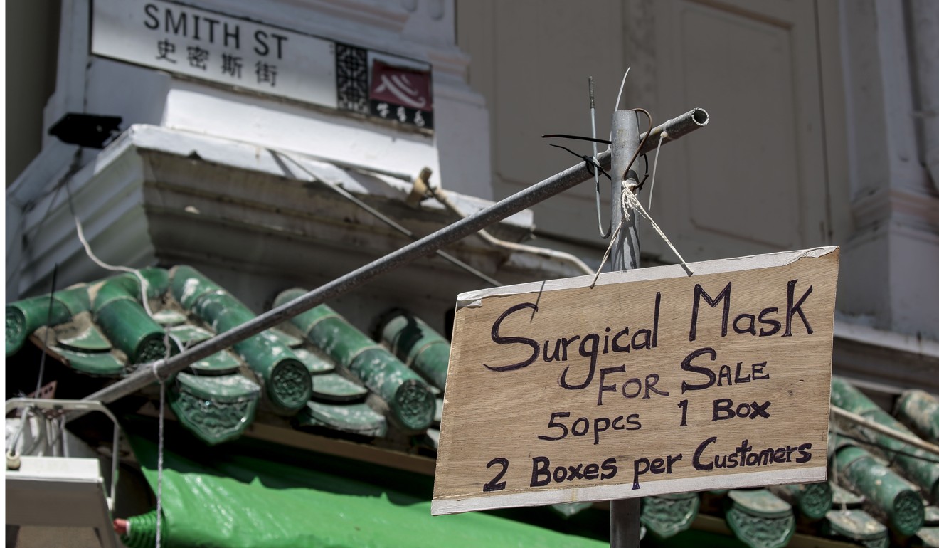 A sign advertising surgical masks for sale in Singapore’s Chinatown. Photo: EPA