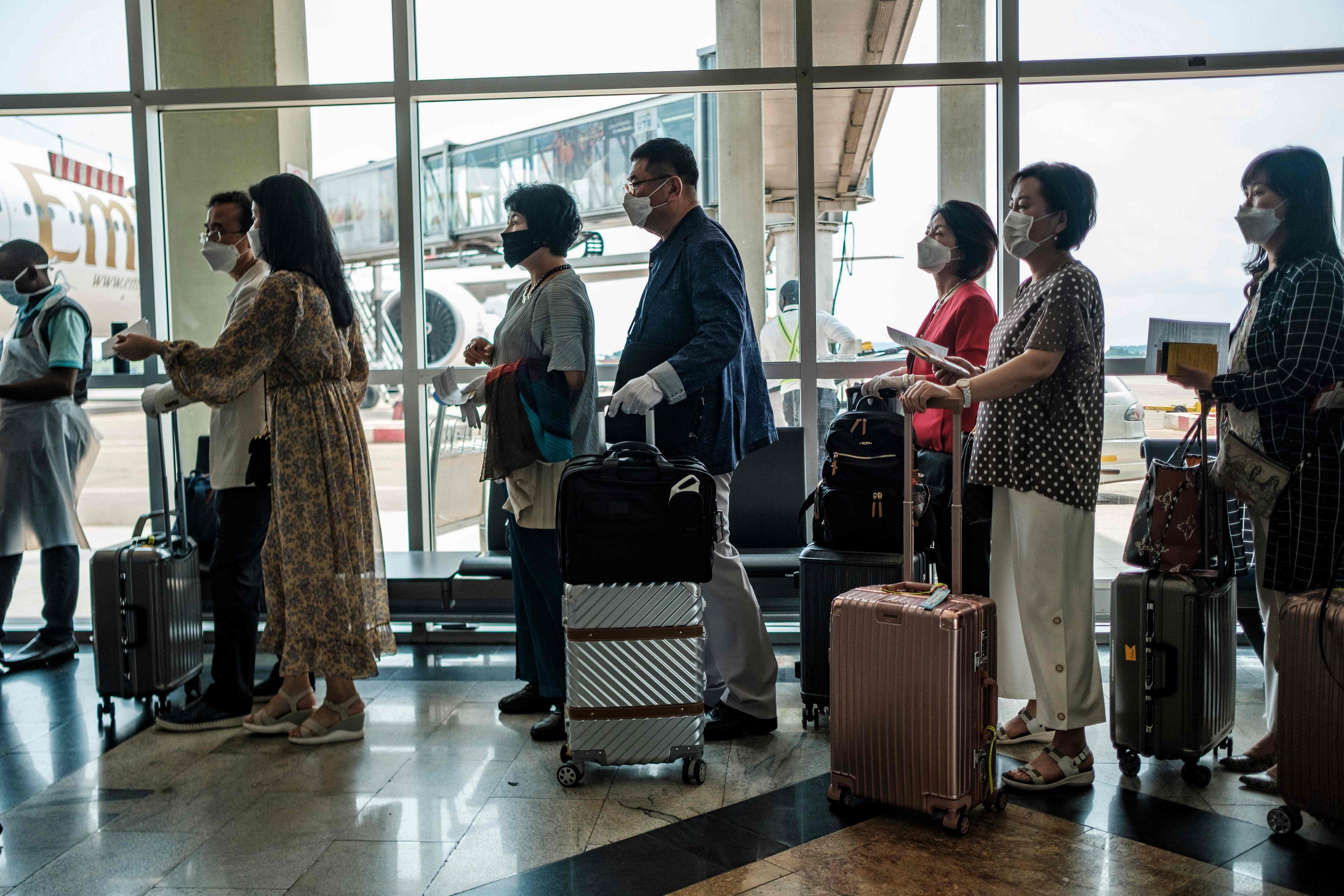 Chinese passengers queue to be screened for coronavirus at Uganda’s Entebbe Airport. Photo: AFP