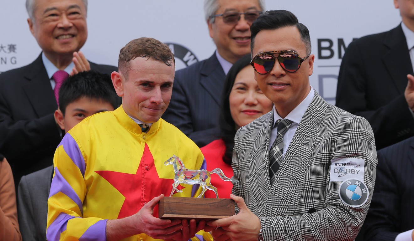 Donnie Yen (right) presents Ryan Moore with the Hong Kong Derby trophy after Ping Hai Star’s win in 2018.