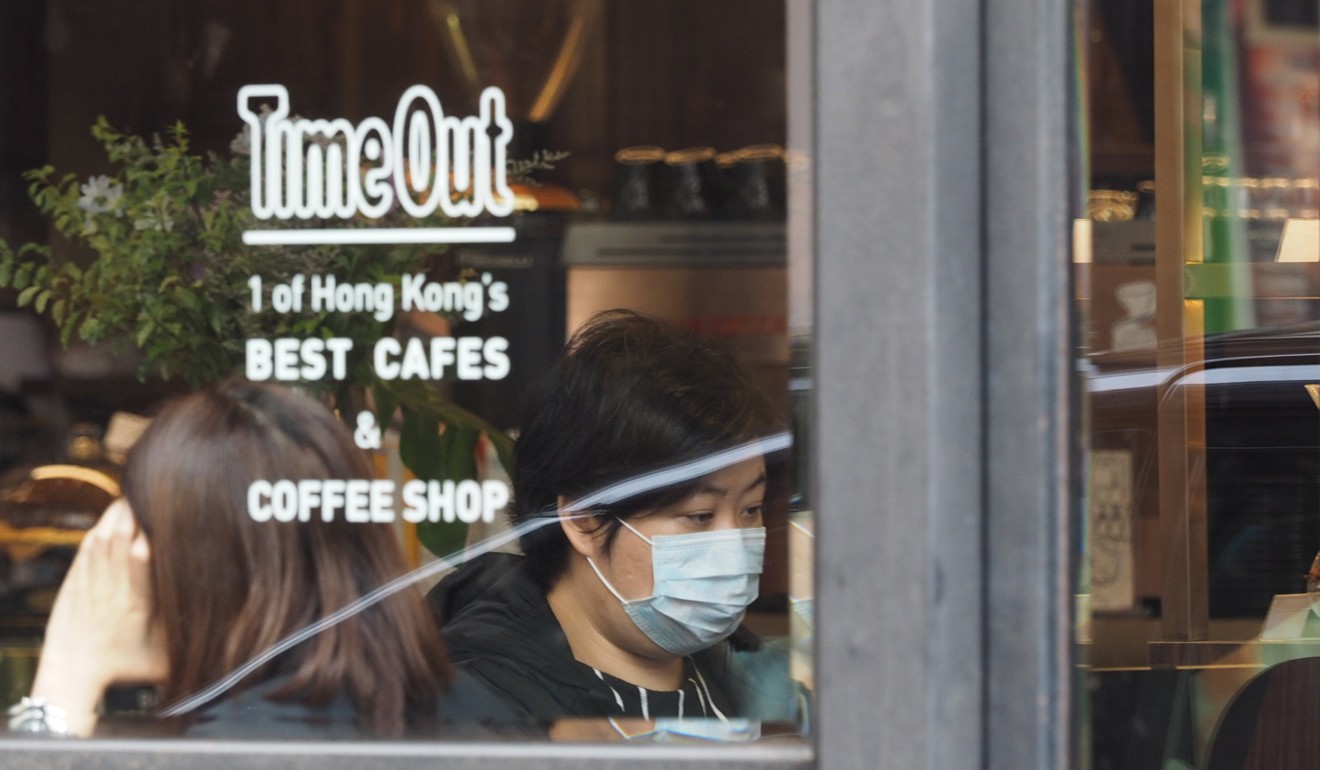 A woman wearing a face mask waits in a coffee shop in Causeway Bay on March 3. Photo: Martin Chan