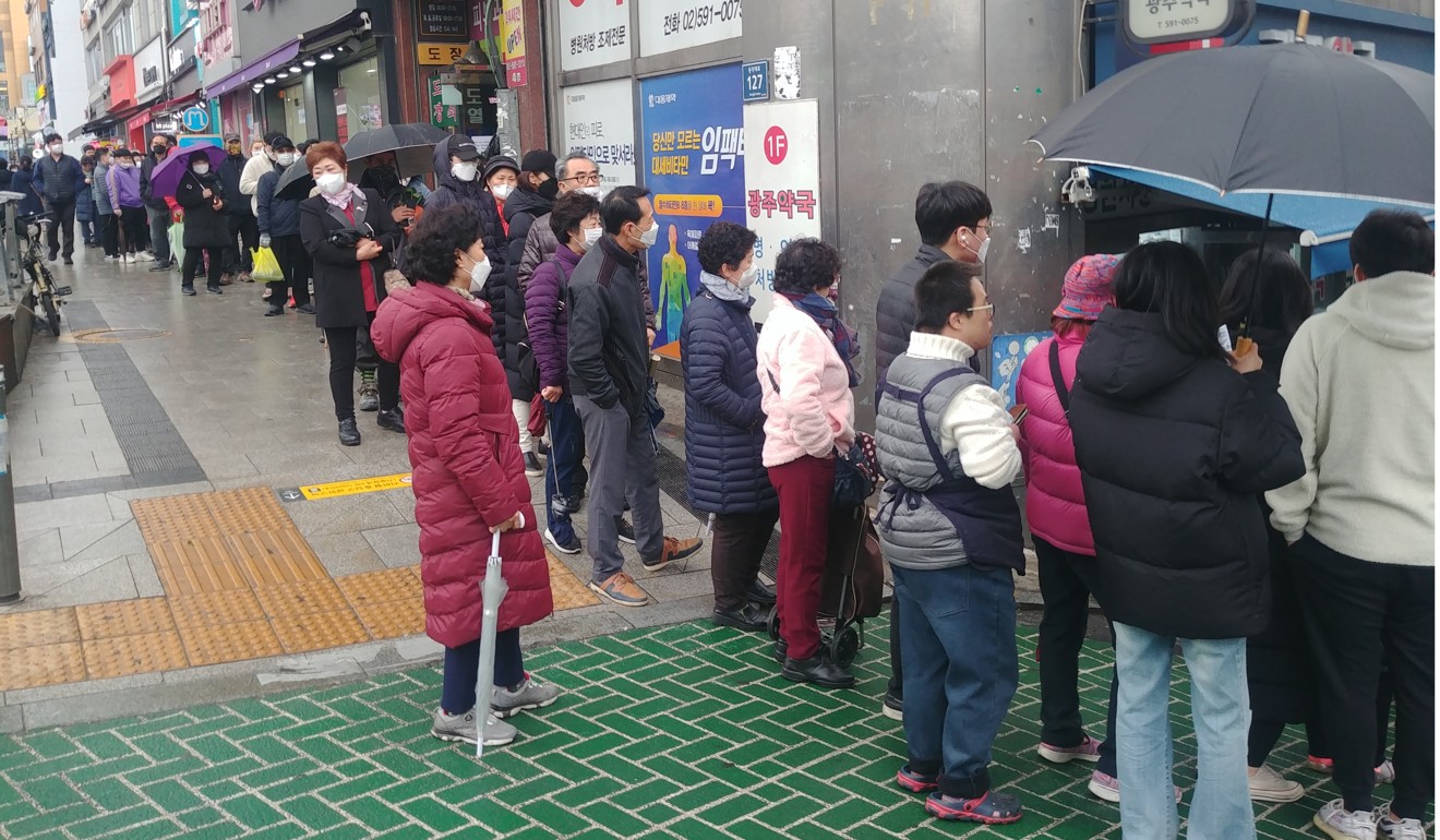 A long queue forms outside a store in Seoul to buy face masks that are in effect being rationed to cope with shortages amid the Covid-19 coronavirus outbreak. Photo: Park Chan-kyong
