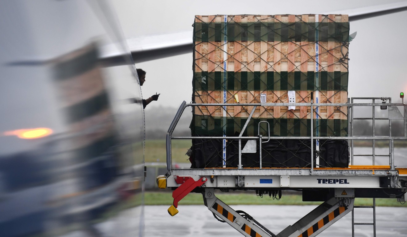 A workers supervises loading of cargo onto a Boeing 747-800. Photo: AFP