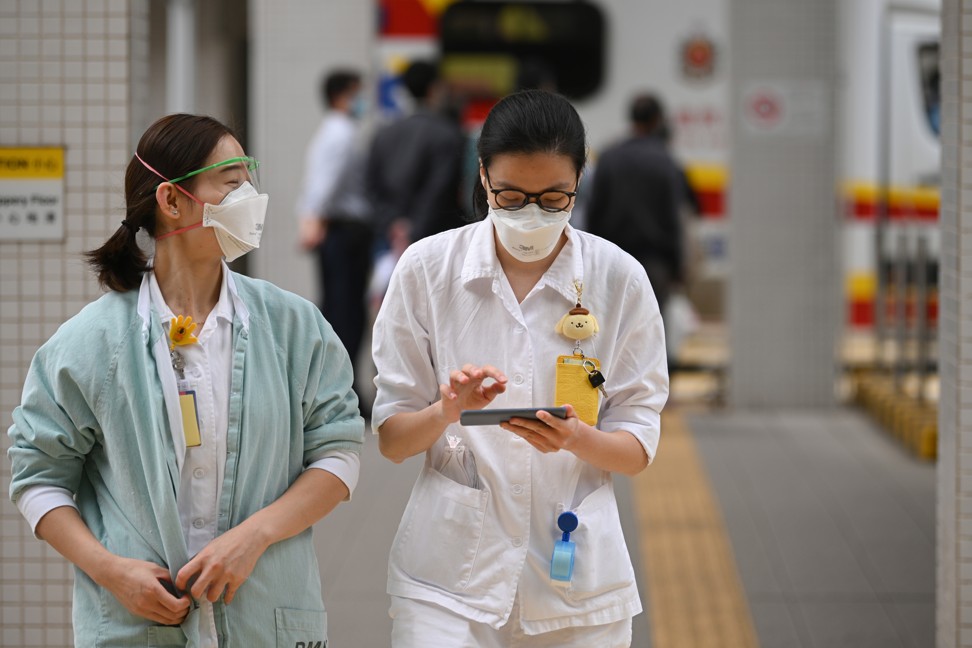 Medical staff in protective gear walk outside Princess Margaret Hospital in Hong Kong. Photo: AFP