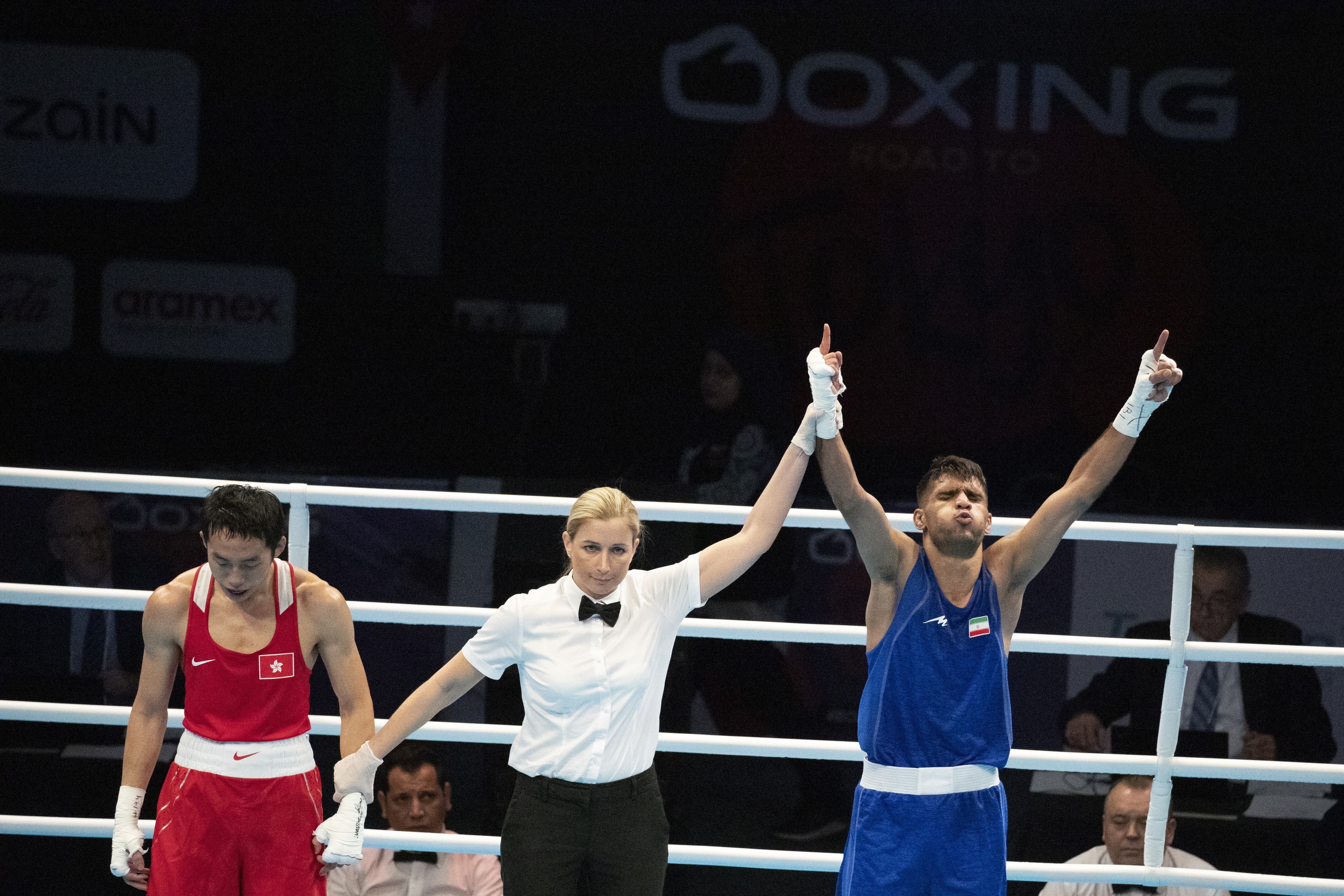 Iran’s Daniyal Shabakhsh raises his arms in triumph after winning his men's featherweight bout against a forlorn looking Rex Tso in Amman. Photo: EPA