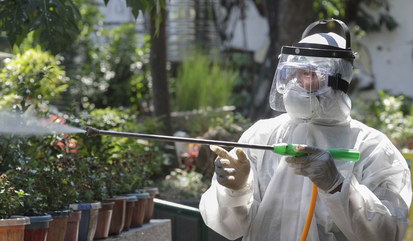 A worker sprays disinfectant at a school which has suspended classes as a precautionary measure against the new coronavirus in San Juan city, east of Manila. Photo: AP