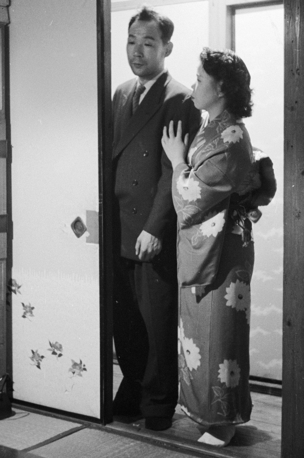 A Japanese prostitute from Yoshiwara, the red light district of Tokyo in the 1960s, shows her client into a private bedroom. Photo: Getty Images