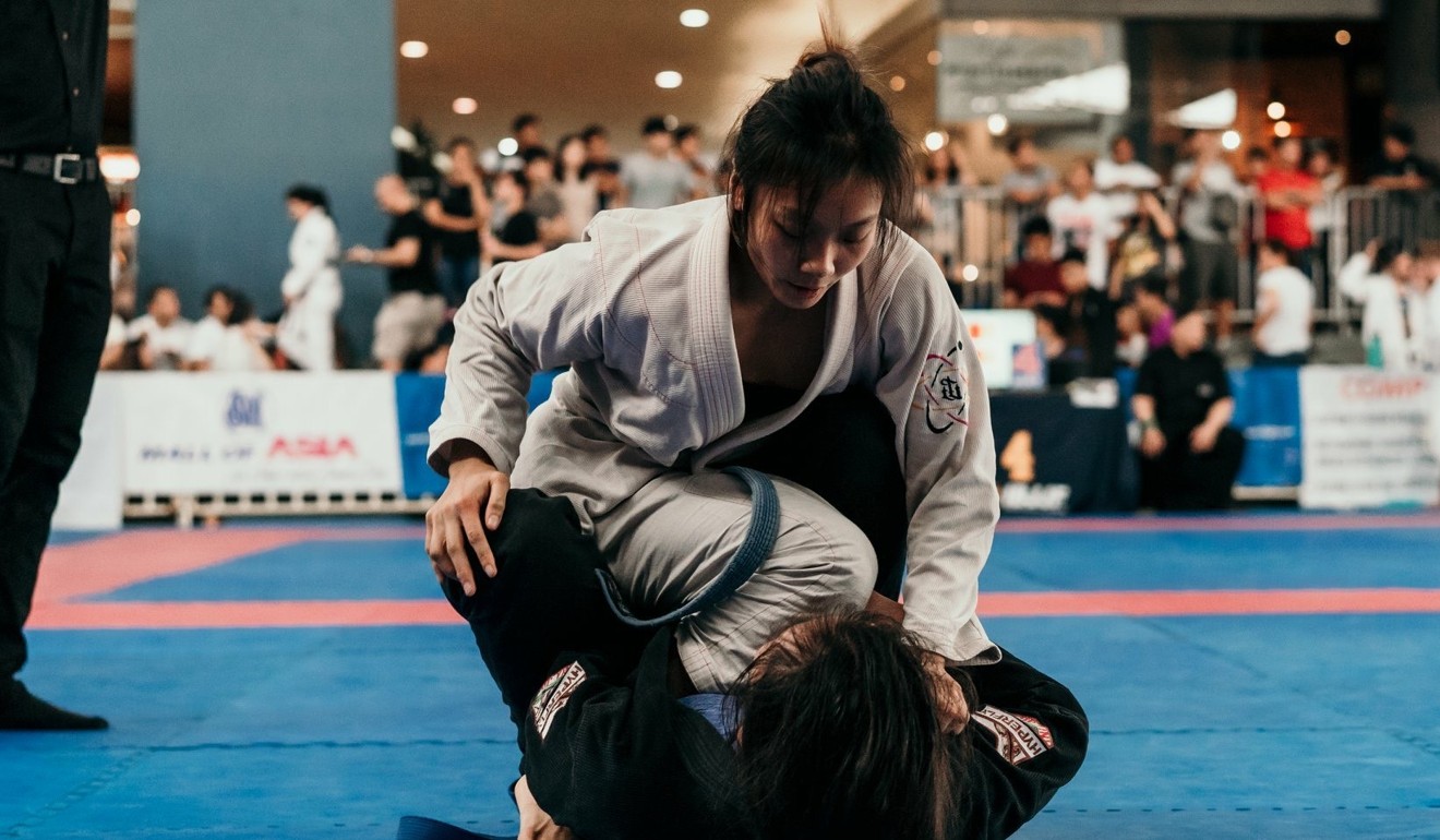 Singapore jiu-jitsu team member Constance Lien takes top position in a grappling tournament. Photo: Nicholas Damien Goh Photography