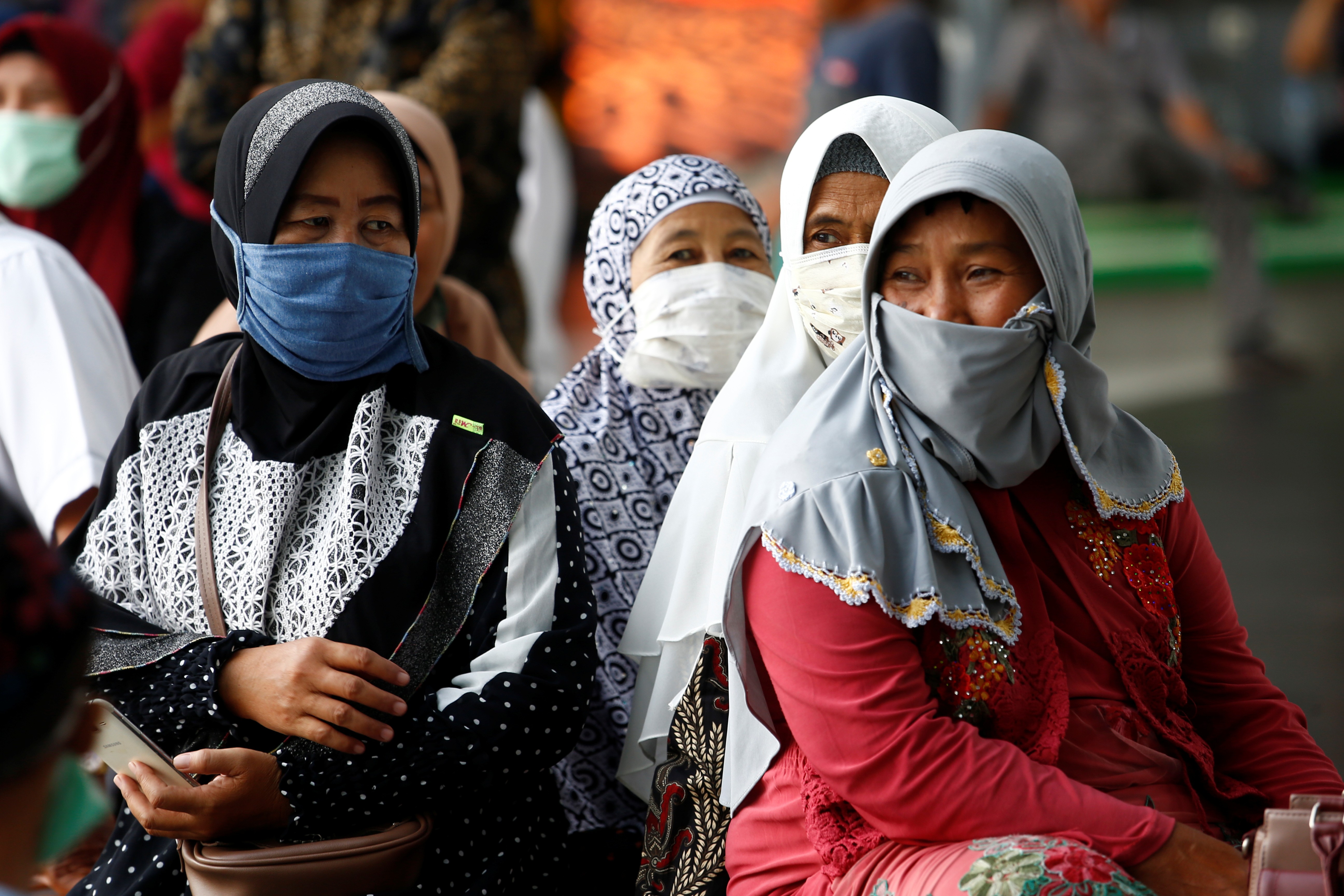 People seen in protective masks at Soekarno Hatta International Airport in Tangerang near Jakarta on March 6, 2020. Photo: Reuters