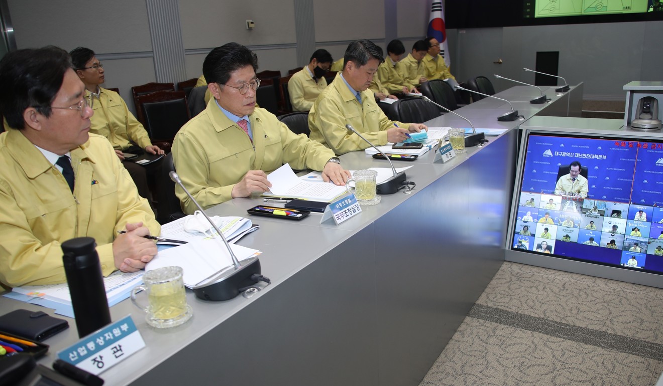 South Korean ministers listen to Prime Minister Chung Sye-kyun (on screen) during a meeting to discuss measures to deal with the spread of the new coronavirus. Photo: EPA